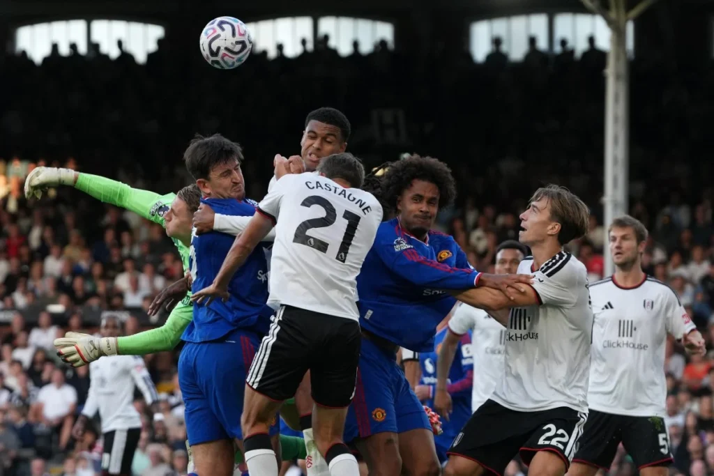 Players fight for the ball in the Fulham goalmouth during the English Premier League football match between Fulham and Manchester United at Craven Cottage in London on September 20, 2026. (Photo by CARLOS JASSO / AFP)